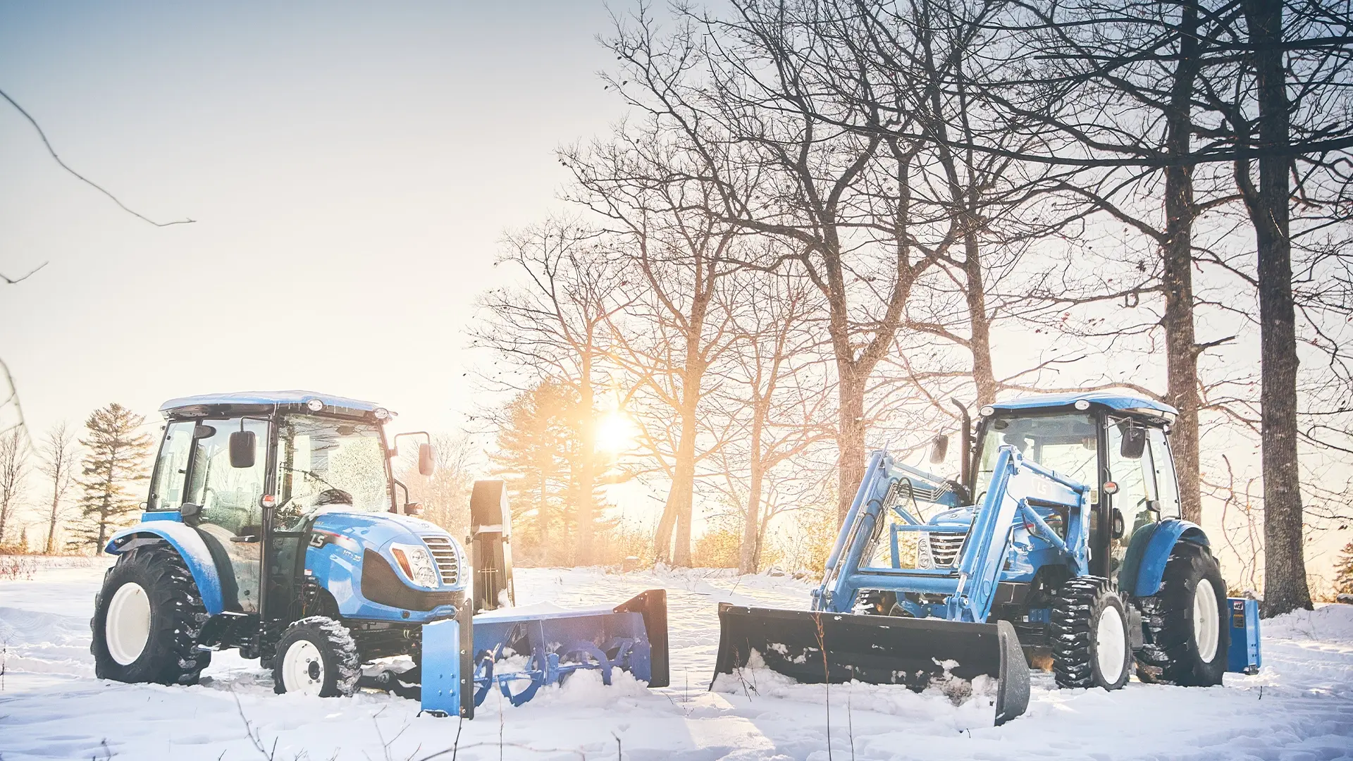 2 ls tractors in the snow
