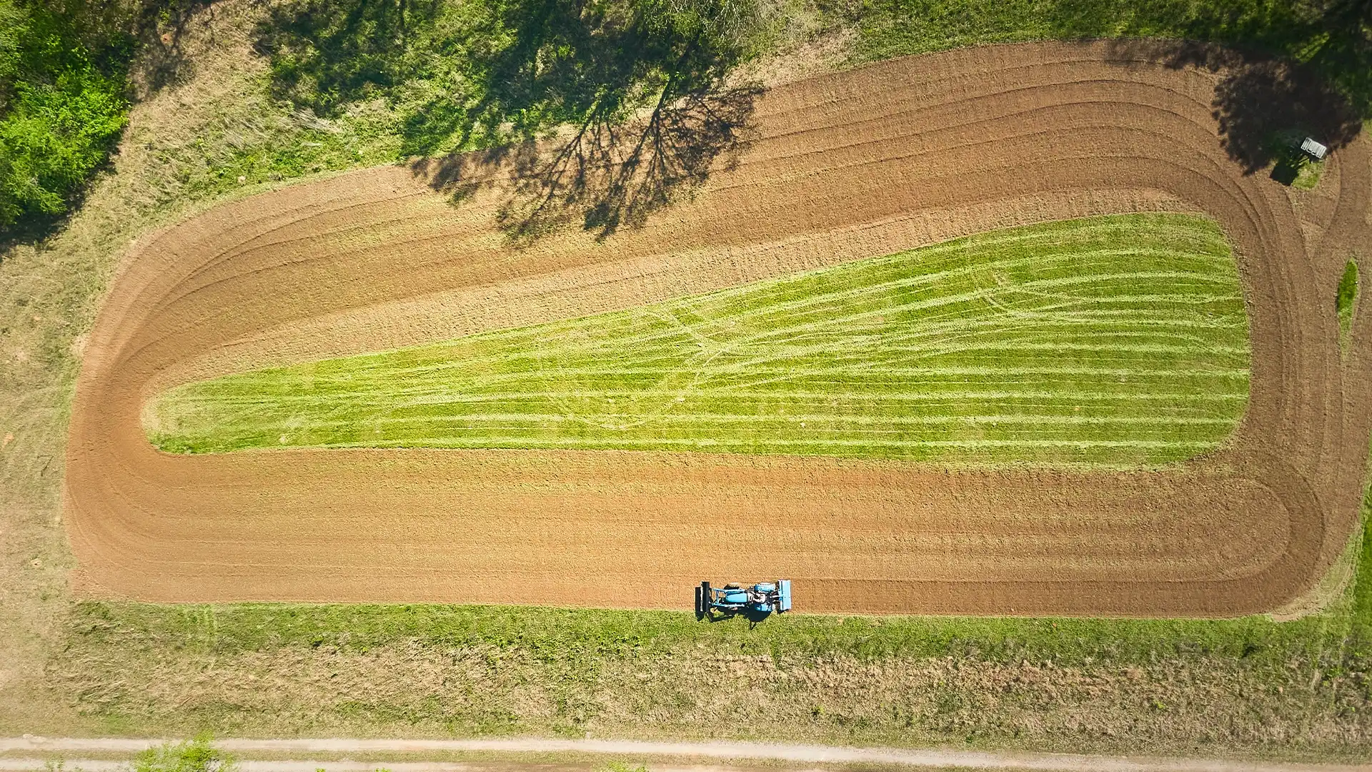 overheard view of a tractor preparing a field